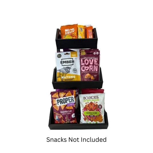 Black snack display with various branded snack packages on a white background