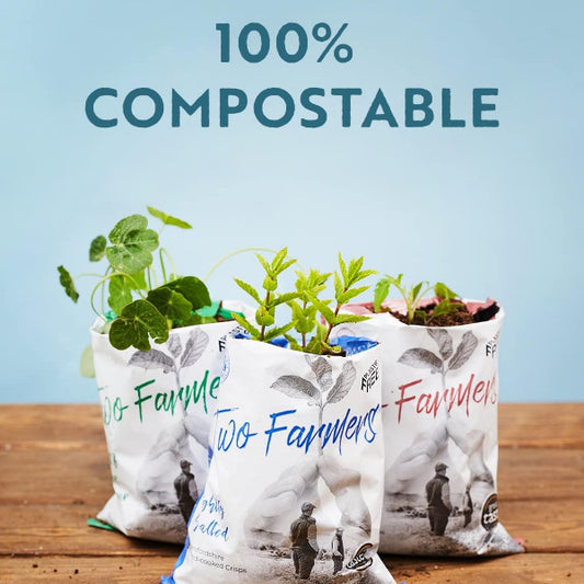 Picture of Two Farmers Crisps packet showing they're 100% compostable with plants growing out of them.