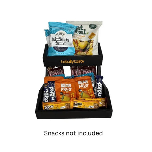 Black snack display with various branded snack packages on a white background