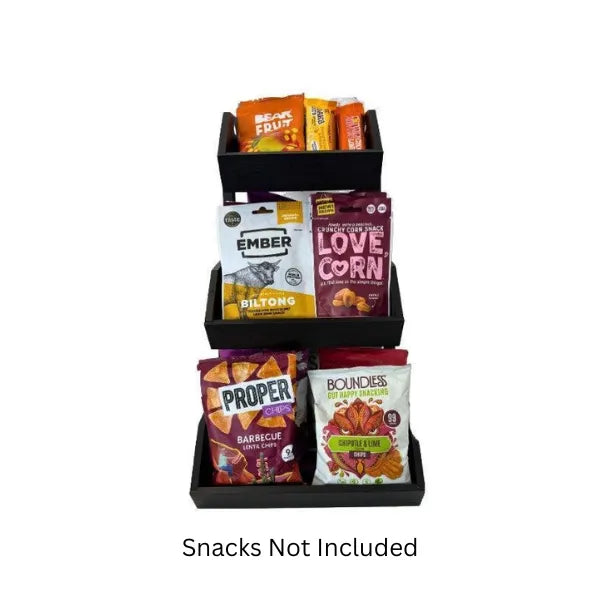 Black snack display with various branded snack packages on a white background