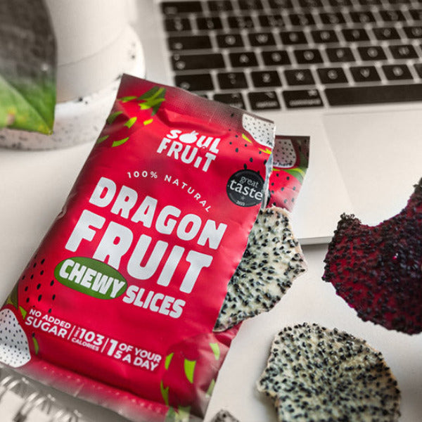 Soul Fruit Dragon fruit chewy slices packaging with a laptop and dragon fruit pieces in the background