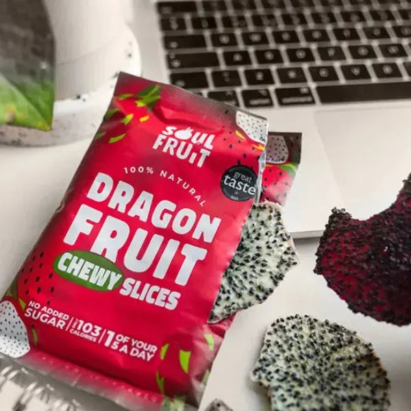 Soul Fruit Dragon fruit chewy slices packaging with a laptop and dragon fruit pieces in the background