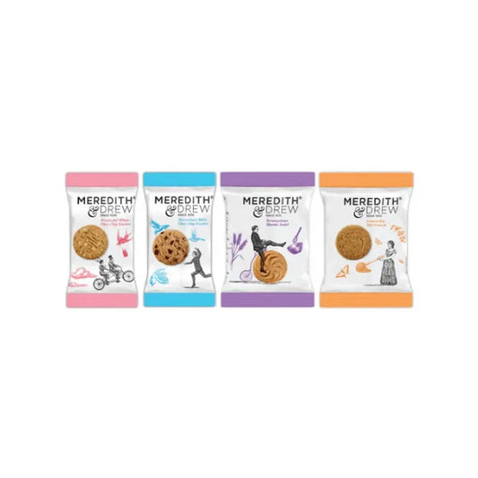 Four packages of Meredith & Drew cookies on a white background