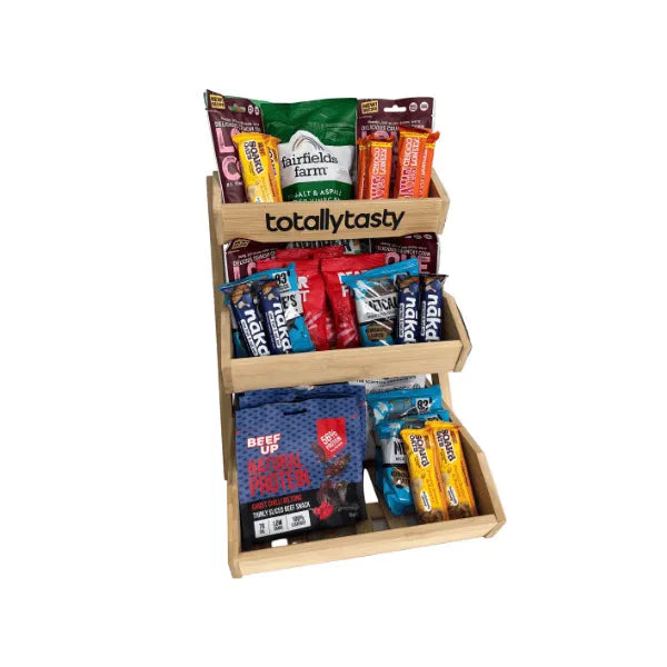 Wooden snack display with various branded snack packages on a white background. Called The City Snacker from Totally Tasty