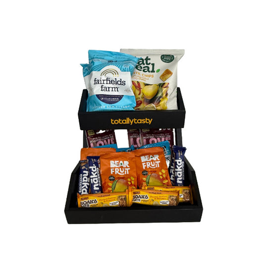 Snack packets in a black tray on a white surface
