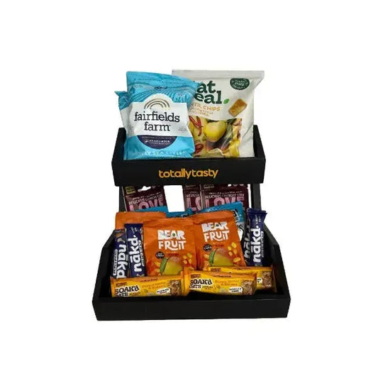 Snack packets in a black tray on a white surface
